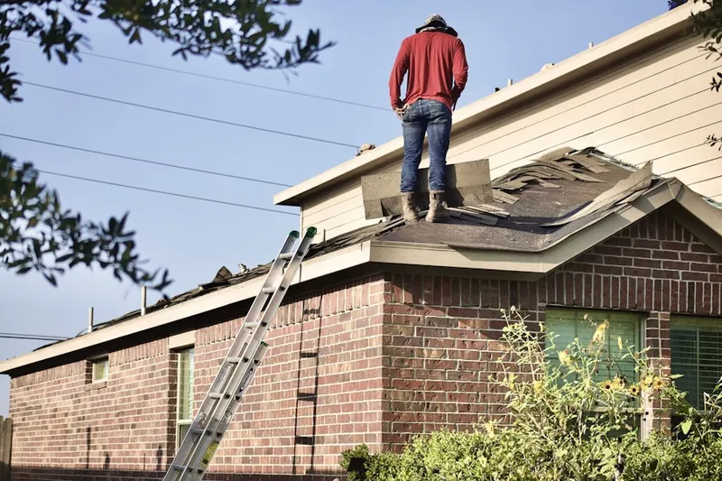Professional roofer working on a residential roof in Wolfforth